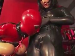 Latex slut made to suck cock